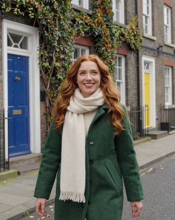 Aoife, 29, Irish woman from Dublin with playful smile on a colorful Georgian street