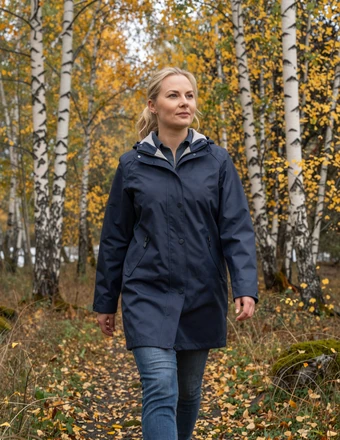 Confident Finnish woman walking through an autumn birch forest with golden leaves
