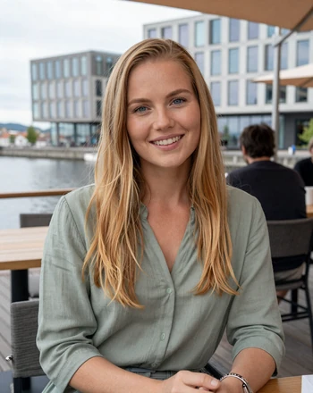 Ingrid, 29, Norwegian woman from Oslo sitting at a waterfront cafe with warm smile