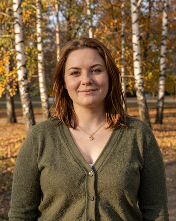 Marta, 33, Latvian woman from Liepāja in an autumn park with birch trees and golden light