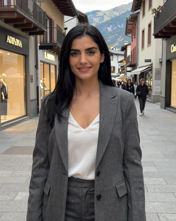 Ariadna, 29, Andorran woman on a shopping street in Andorra la Vella with luxury stores and mountain views